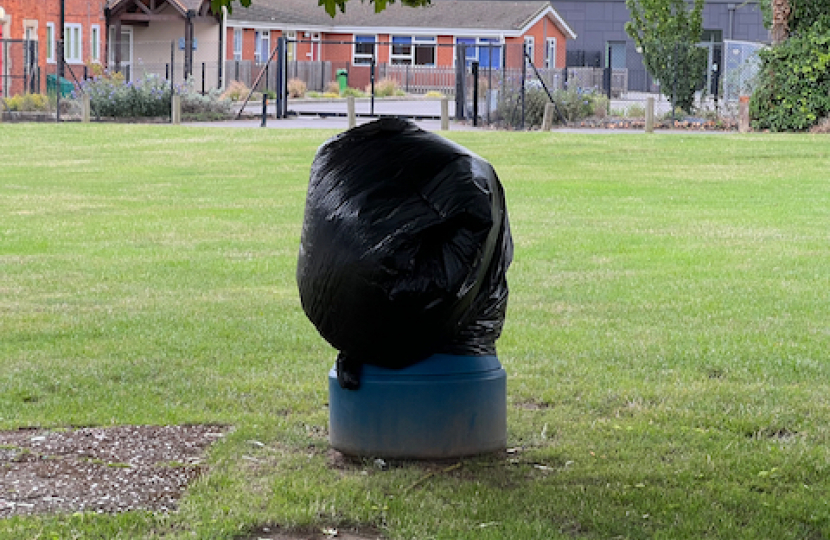 Litter bin covered with black bag