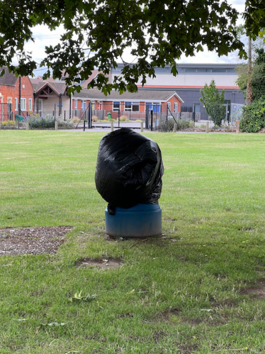 Litter bin covered with black bag